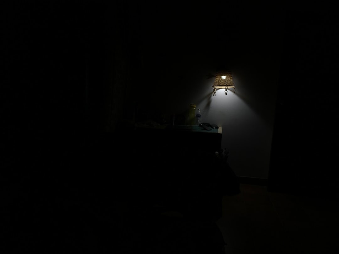Dramatic spotlight and camera flashes in a dark room