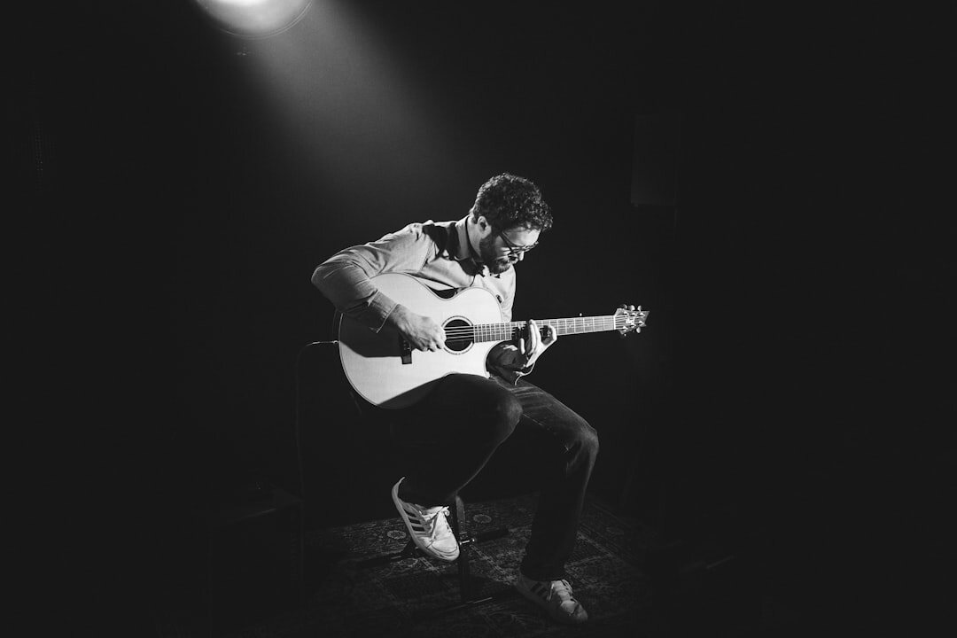 man playing guitar on stage